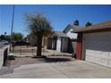 View of home from driveway showing the garage and landscaping at 115 Parrish Ln, Las Vegas, NV 89110
