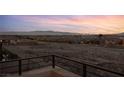Balcony view showcasing a cityscape and distant mountain range at sunset at 1172 Monte De Luz Way, Henderson, NV 89012