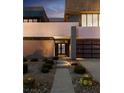 Contemporary two-story home with desert landscaping leading to a walkway and two-car garage at 1172 Monte De Luz Way, Henderson, NV 89012