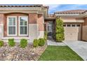 Charming home featuring manicured landscaping, a private courtyard, and a two-car garage at 11730 Stonewall Springs Ave, Las Vegas, NV 89138