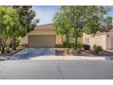 Charming home exterior showcasing a two-car garage, well-manicured landscaping, and a welcoming entrance with stone accents at 1375 Gran Vista Ave, Henderson, NV 89012