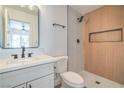 Modern bathroom with a stand-up shower featuring wood paneling and stylish fixtures at 1945 Margarita Ave, Henderson, NV 89011