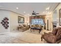 Elegant living room featuring recessed lighting, a cozy fireplace, and neutral-toned furnishings at 2021 Evansdale St, Henderson, NV 89052