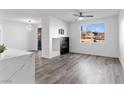 Bright living room featuring gray wood flooring, modern fireplace, and a large window for ample natural light and neighborhood views at 2325 Windmill Pkwy # 1711, Henderson, NV 89074