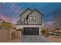 View of the front exterior featuring an attached garage, second story patio, and landscaping at 3069 Lascari Ave, Henderson, NV 89044
