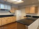 Bright kitchen with wood cabinets, dark countertops, and stainless steel appliances at 332 Wild Plum Ln, Las Vegas, NV 89107