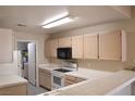 Bright kitchen featuring a smooth top range, microwave, and tile countertops at 3672 Angela Robin St # 202, Las Vegas, NV 89129