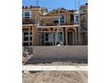New home under construction showcasing wood framing, window placements, and brick base at 3759 Via Allegro, Henderson, NV 89044