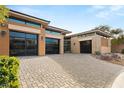 Contemporary desert home featuring brick and stucco accents, desert landscaping and garages at 39 Cranberry Cove Ct, Las Vegas, NV 89135