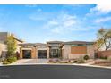 Contemporary desert home featuring desert landscaping, large windows and three car garage at 39 Cranberry Cove Ct, Las Vegas, NV 89135
