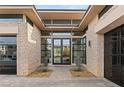 Elegant double door entry with stone accents and desert landscaping at 39 Cranberry Cove Ct, Las Vegas, NV 89135