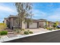 Beautiful single story home with a three-car garage and desert landscaping at 440 Point Sur Ave, Las Vegas, NV 89138