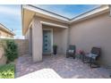 Inviting covered front porch with chairs and brick flooring at 440 Point Sur Ave, Las Vegas, NV 89138