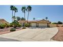 Charming single-story home with palm trees and a large driveway leading to a two-car garage at 5217 Cold River Ave, Las Vegas, NV 89130