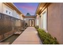 Inviting entrance featuring a decorative water feature, mature landscaping, and a modern walkway at 540 Regents Gate Dr, Henderson, NV 89012