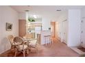 Dining area open to the kitchen features a table and chairs with a view to hallway at 5415 W Harmon Ave # 1119, Las Vegas, NV 89103