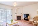Bright living room with sliding glass door, fireplace, and comfortable seating area at 5415 W Harmon Ave # 1119, Las Vegas, NV 89103