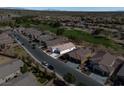 Community aerial shot of a single-story home on a tree-lined street near a golf course at 5675 E La Campana Dr, Pahrump, NV 89061