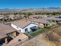 Aerial view of the backyard with patio, gazebo, lush lawn, and mountain views at 5675 E La Campana Dr, Pahrump, NV 89061
