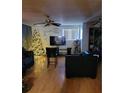 Cozy living room featuring hardwood floors, a Christmas tree, and a television at 5809 Pebble Beach Blvd, Las Vegas, NV 89108