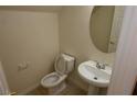 Half bathroom featuring a pedestal sink, modern toilet, and neutral wall color at 6020 Genovese Ave, Las Vegas, NV 89141
