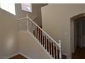 Bright staircase with white banister and wood-look flooring leading to the upper level at 6020 Genovese Ave, Las Vegas, NV 89141