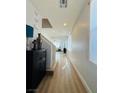Bright hallway with wood floors, leading to living area with lots of natural light, enhancing the home's appeal at 6495 Little Harbor Ct, Las Vegas, NV 89141