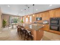 Modern kitchen with a large island, stainless steel appliances, and an adjacent dining area at 8216 Swallow Falls St, North Las Vegas, NV 89085