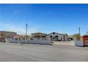 Wide angle of the home, showing the gated entry and horseshoe driveway at 8365 Haven St, Las Vegas, NV 89123