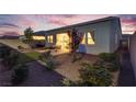 A cozy backyard with a seating area, privacy fence, and well-maintained landscaping at 8944 Skye Canyon Ranch St, Las Vegas, NV 89166