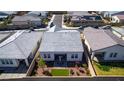 Aerial view of a modern home, highlighting the well-maintained backyard with patio area and green artificial turf at 8944 Skye Canyon Ranch St, Las Vegas, NV 89166
