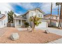 Charming two-story home with a well-maintained lawn, two-car garage, and desert landscaping at 9004 Crystal Glass Dr, Las Vegas, NV 89117