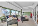 Bright and airy sunroom filled with natural light, wicker furniture, and a view of the outdoors at 9037 Grayling Dr, Las Vegas, NV 89134