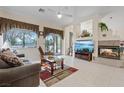 Bright living room with tile floors, fireplace, and sliding door with backyard views offering comfort and style at 10563 Sunblower Ave, Las Vegas, NV 89135
