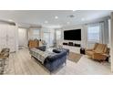 Bright living room with tile floors, a large TV, and comfortable seating at 134 Lomita Heights Dr, Las Vegas, NV 89138