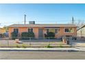 Simple single-story home with gravel front yard and chain link fence at 1805 Helen Ave, North Las Vegas, NV 89032