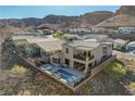 Aerial view of the home with its stunning backyard pool, patio, and neighborhood setting against a mountain backdrop at 1968 Regal Bluff Dr, Henderson, NV 89052