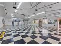 Spacious garage with checkered floor and high ceilings, offering ample storage and workspace at 2101 Strada Mia Ct, Las Vegas, NV 89117