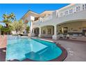 Inviting pool and outdoor kitchen with bar seating, great for entertaining and relaxation at 2101 Strada Mia Ct, Las Vegas, NV 89117