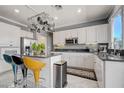 Bright kitchen features white cabinetry, stainless steel appliances, and granite countertops at 2726 Manteno Ct, Henderson, NV 89052