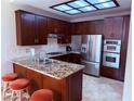 Modern kitchen features stainless steel appliances, granite counters, and custom cabinets at 2796 Cape Hope Way, Las Vegas, NV 89121