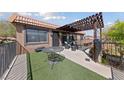 This rooftop patio features a pergola, astro turf, wrought iron railing, and an outdoor seating area at 320 Shadybrook Ln # D, Las Vegas, NV 89107