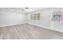 Bright living room with ceiling fan and light gray wood flooring at 3929 Torsby Pl # 3929, Las Vegas, NV 89119