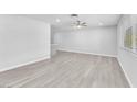 Bright living room with ceiling fan and light gray wood flooring at 3929 Torsby Pl # 3929, Las Vegas, NV 89119