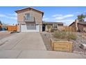 Charming two-story house with a garage, balcony, xeriscaping, and a view of the home's address at 429 Sunburst Dr, Henderson, NV 89002