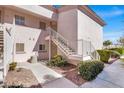 Exterior of a condo with a private entrance, well maintained landscaping and secure stairs at 4555 E Sahara Ave # 120, Las Vegas, NV 89104