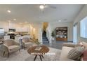 Bright, staged living room with modern finishes and an open floorplan at 4790 Equinox Sky Ave # 2, North Las Vegas, NV 89084