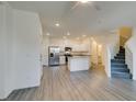 Bright living room and kitchen space with stairs leading to the upper level at 4790 Equinox Sky Ave # 2, North Las Vegas, NV 89084