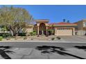 Well-maintained home with a terracotta roof, manicured landscaping, and a spacious two-car garage at 4936 Mountain Foliage Dr, Las Vegas, NV 89148