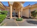 Inviting home exterior featuring a tiled roof, statue accent, and covered entryway at 4936 Mountain Foliage Dr, Las Vegas, NV 89148